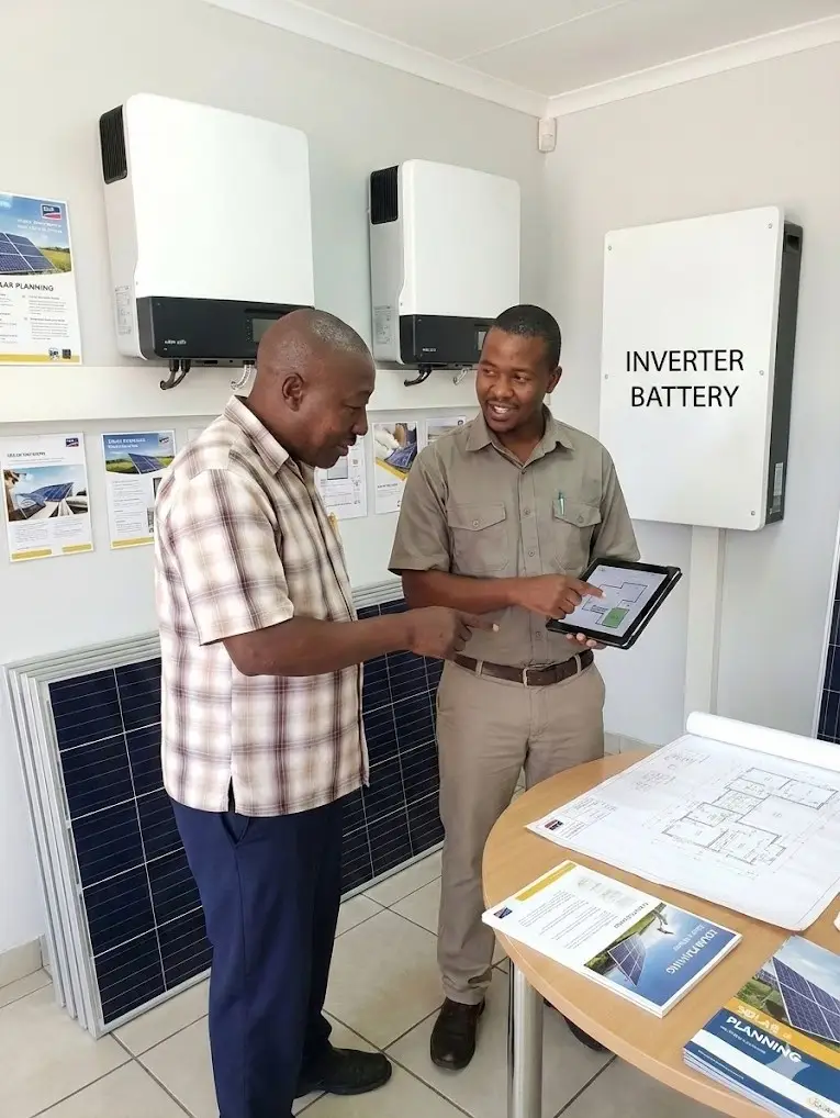 Solar consultant reviewing off-grid system design with a client